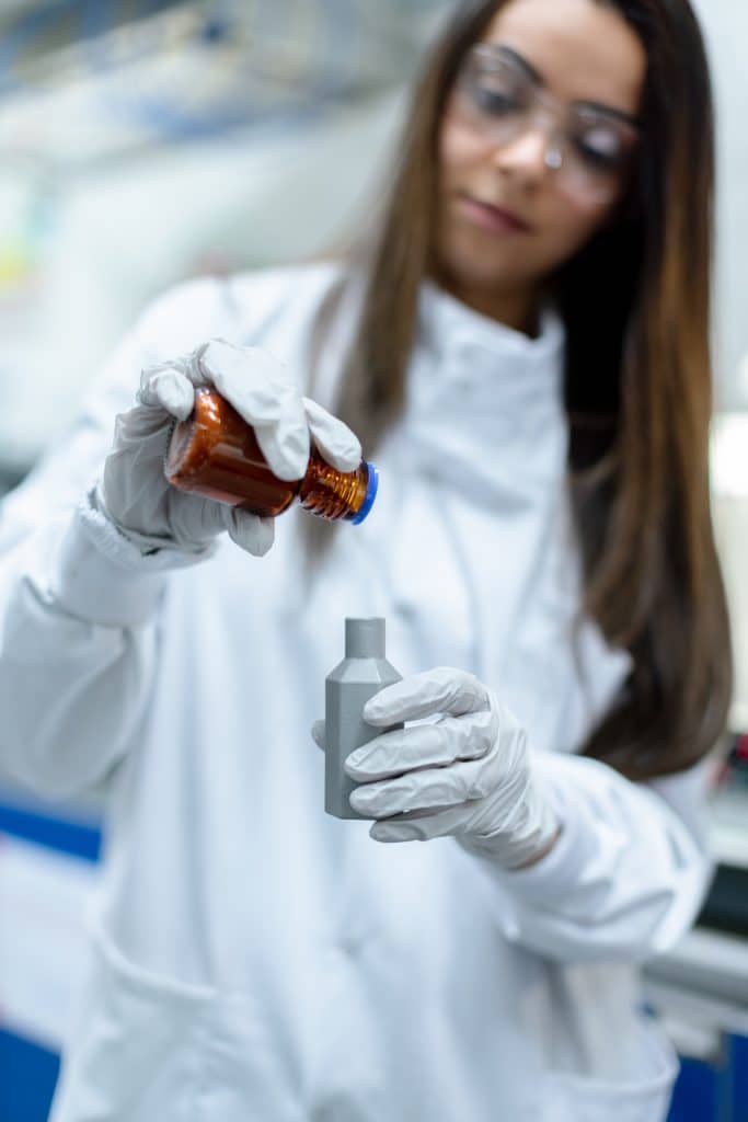 laboratory technician transferring vials
